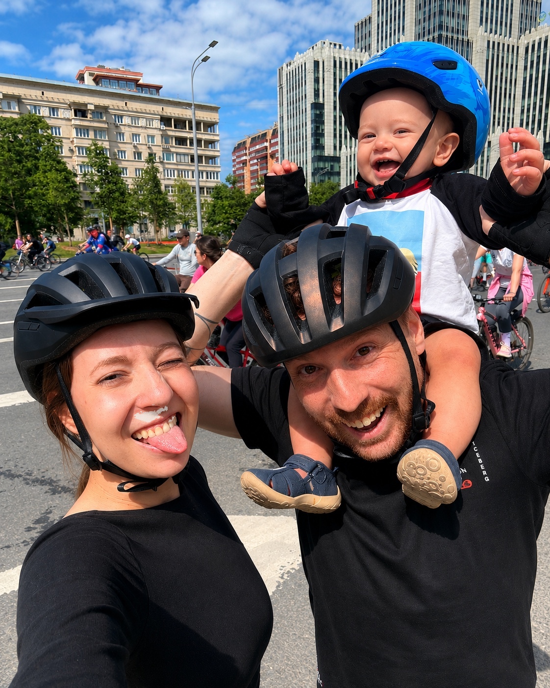 Matthew Rausch with his wife and child, wearing cycling helmets on a family outing.